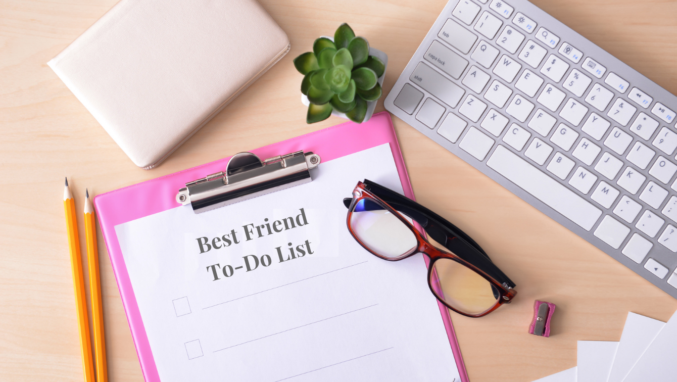 A desk with a computer keyboard, glasses, small potted plant, two pencils and a clipboard holding a paper that reads, "Best Friend To-Do List"