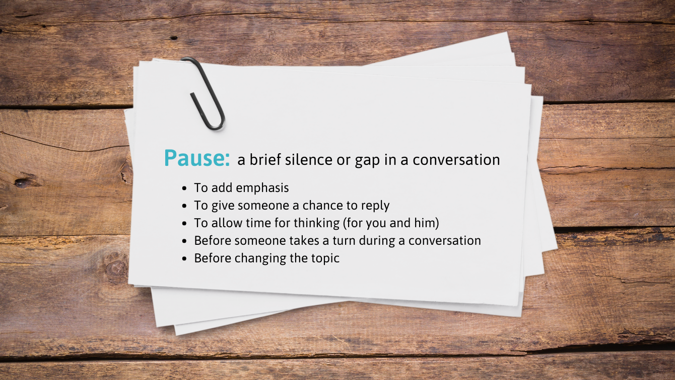 A note on a wooden table is titled, "Pause: a brief silence or gap in a conversation". It reads, 1. To add emphasis. 2. To give someone a chance to reply. 3. To allow time for thinking (for you and him. 4. Before someone takes a turn during a conversation. 5. Before changing the topic.)