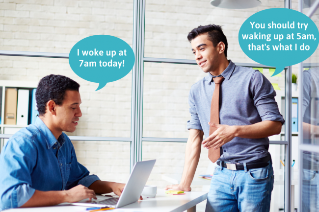 Two male friends in an office. One says he woke up at 7 am, and the other one-ups him by saying he woke up at 5 am.