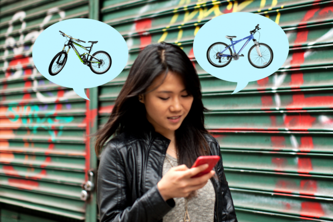 A person walking with her phone asking someone her opinion on the color of bikes. 